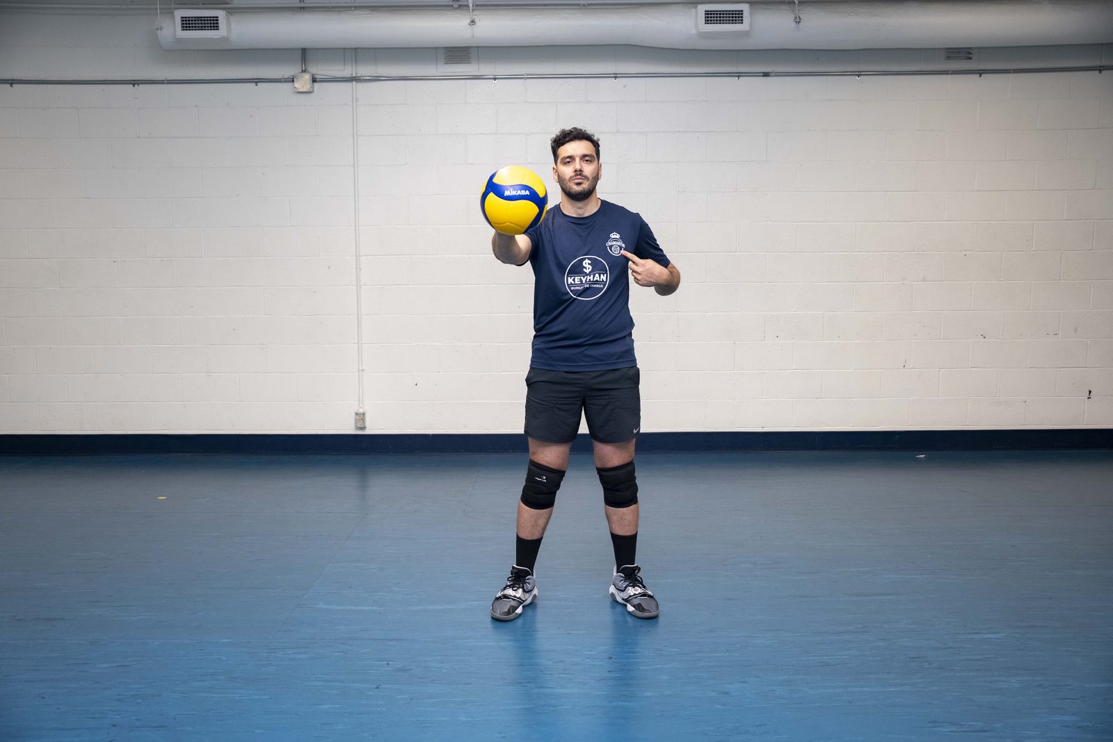 Coach Moeen holding a volleyball